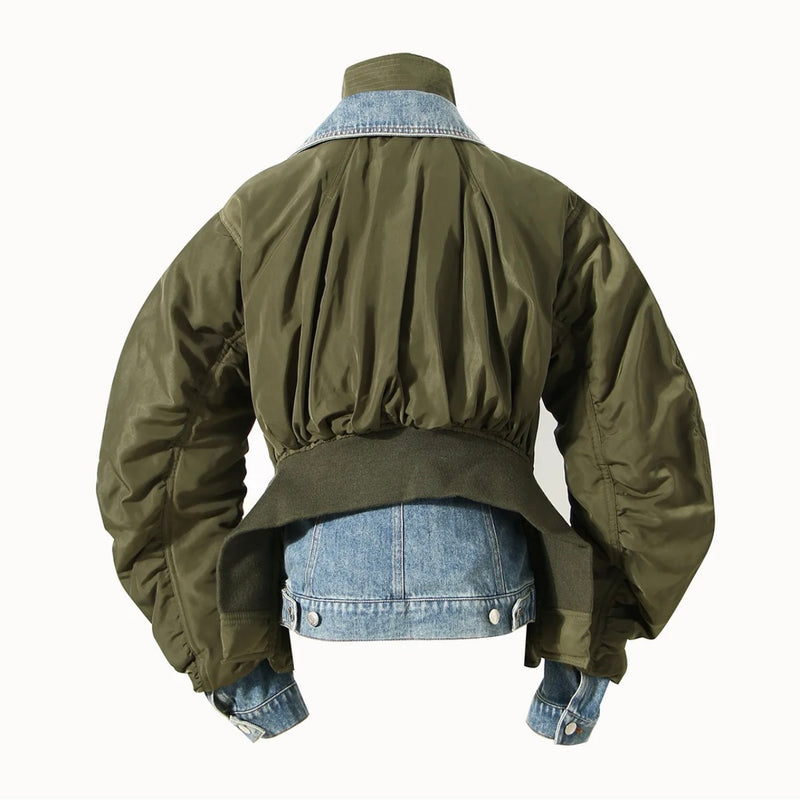 Light, medium blue, stonewashed denim and army green nylon contrast fabrics. Silver zippers and buttons, orange lining, orange stitching on the denim parts of the jacket with army green stitching on the army green parts of the jacket. Two contrasting collars and four fully functioning jacket pockets. Two pockets with snap buttons, two with rivet buttons. Jacket features a two-way zipper and also buttons up.  Adjustable tabs with rivet buttons at the back waist. No stretch. True to size fit.