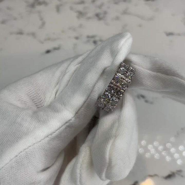 A beautiful band to wear alone or paired up with the Square Pear Ring for a super bomb, head turning look! Clear, brilliant, platinum plated, round cut, 4mm, A+++ CZ crystal stone band. Available in multiple sizes Expect to get up to 1 year worth of tarnish proof, water resistant wear from all of our jewelry with proper care. Hypoallergenic.