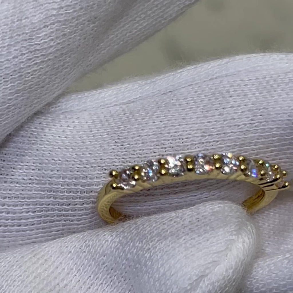 Cute, dainty and stackable! Now, that's a vibe...  18k gold plated, clear, brilliant, micro A+++ CZ round cut stones on a thin gold band.  Made perfectly to be worn individually, in multiples or in addition to other ring stacks.  Expect to get up to 1 year worth of tarnish proof, water resistant wear from our jewelry with proper care. Hypoallergenic.