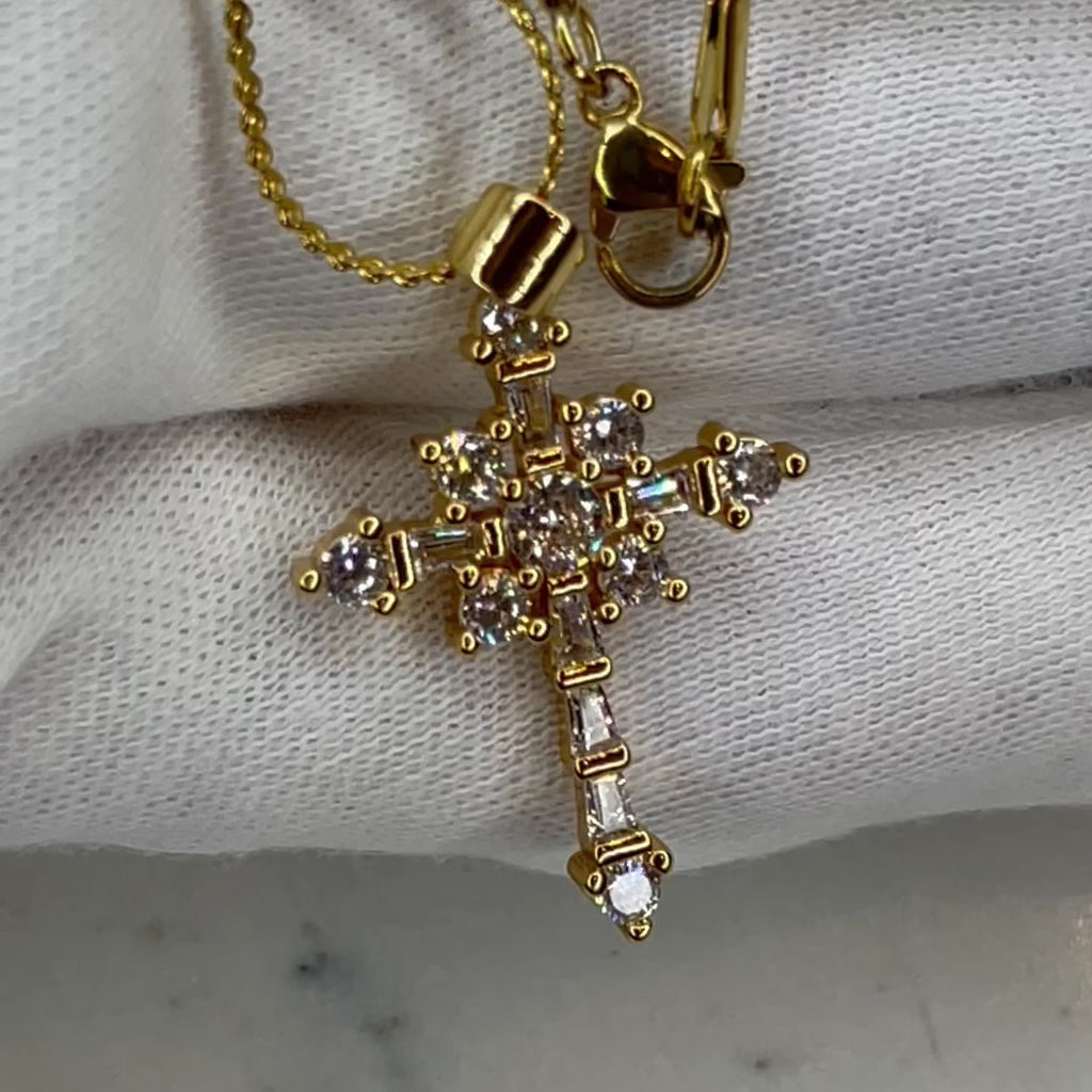 Unique and super luxurious cross pendant necklace made to stand out the crowd!  18k gold plated, round and baguette crystal stone cross pendant necklace. 1" in length 1/2" wide on a 20", serpentine chain necklace. Pendant can be removed from chain and placed on any other chain.   Expect to get up to 1 year worth of tarnish proof, water resistant wear from our jewelry with proper care. Hypoallergenic.