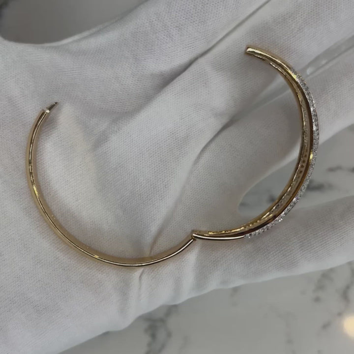 Named the 1 of 1 Bangle because that's just how unique this beauty is. It's a Zoe Mar favorite and we don't use the word favorite loosely. Impeccable craftmanship and quality! You'll have this bracelet for years and it will still look the same as the day you bought it.  2 1/2" in diameter at it's widest point. Bangle has a clasp closure that can be opened and snapped closed securely to fit most sized wrists. 18k gold plated, A+++ crystal baguette and pave stones. 