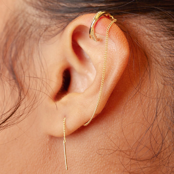 The best thing about this ear cuff is how many ways you can wear it. Wear two at the same time to really stand out. Wrap the threader around the ear, behind or in front of the ear for a completely different look on both ears or just wear one Euphoria Ear Cuff at a time. Talk about versatility!   Handmade, 18k gold plated, A+++ CZ stones, ear cuff if 4mm in width and the threader that goes in to the pierced part of the ear is 4" in length.