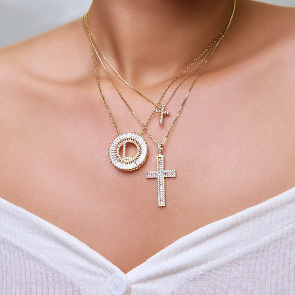 These necklaces are for sure head turners with several letter options to choose from!  Pendants are 1" round in diameter, made of top quality baguette and pave crystals set in 18k gold plating and hung from a 18", gold plated, cable chain necklace. Pendants can be removed from necklace and placed on any other necklace of your choice.   Stack it with the Cross to Bear Necklace and the Mini Cross Necklace for a complete look!