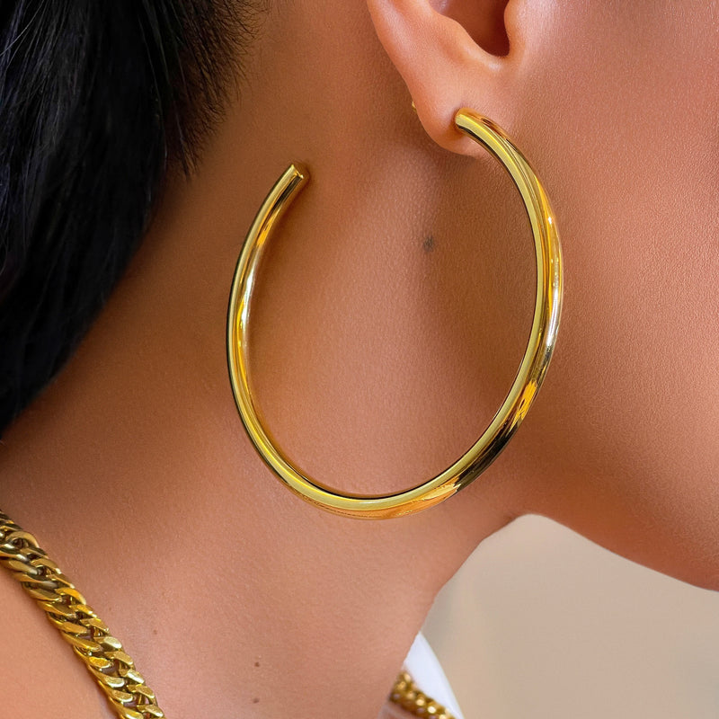 Shiny and so luxurious. These are not your typical, regular degular hoops. Impeccably made from quality materials. These babies are a must have in any collection. They even have custom earring backs! How cool is that?!  Handmade, 3" circumference, 18k gold plated, custom post earring back, hoop earrings.  Expect to get up to 1 year worth of tarnish proof, water resistant wear from our jewelry with proper care. Hypoallergenic.