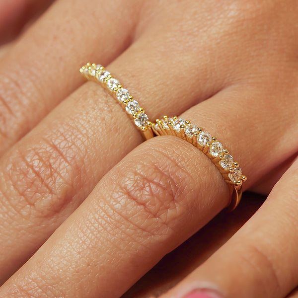 Cute, dainty and stackable! Now, that's a vibe...  18k gold plated, clear, brilliant, micro A+++ CZ round cut stones on a thin gold band.  Made perfectly to be worn individually, in multiples or in addition to other ring stacks.  Expect to get up to 1 year worth of tarnish proof, water resistant wear from our jewelry with proper care. Hypoallergenic.
