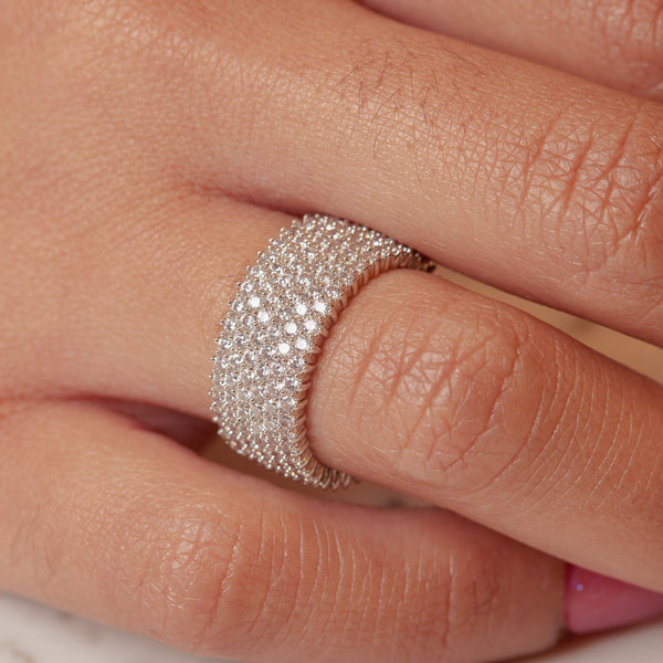 This band is beyond stunning! The pavé setting gives it a lustrous sparkle that glows in bright lighting or dim settings. A must have for any collection...  Clear, brilliant, platinum plated, round cut, pavé, A+++ CZ crystal stone band.  Expect to get up to 1 year worth of tarnish proof, water resistant wear from our jewelry with proper care. Hypoallergenic.